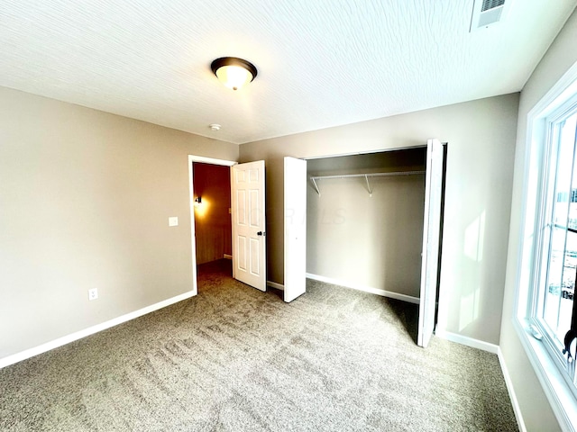 unfurnished bedroom with a closet and carpet