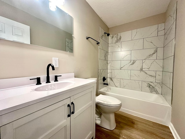 full bathroom with toilet, a textured ceiling, vanity, tiled shower / bath combo, and hardwood / wood-style flooring