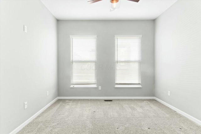 unfurnished room featuring light colored carpet and ceiling fan