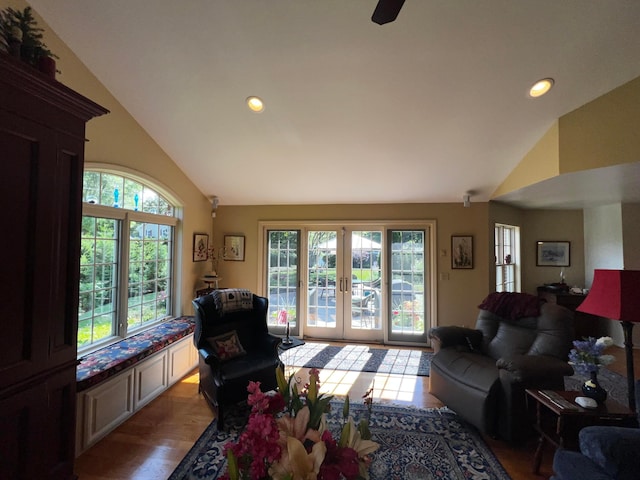 living room with french doors, a healthy amount of sunlight, and vaulted ceiling