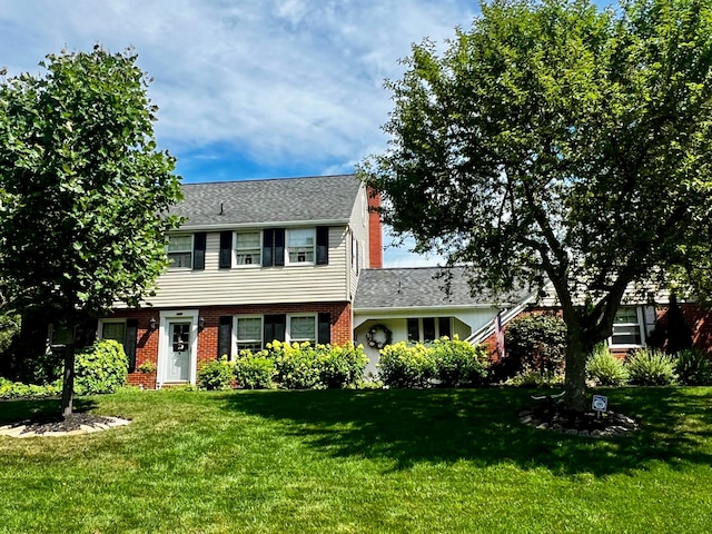 colonial home with a front lawn