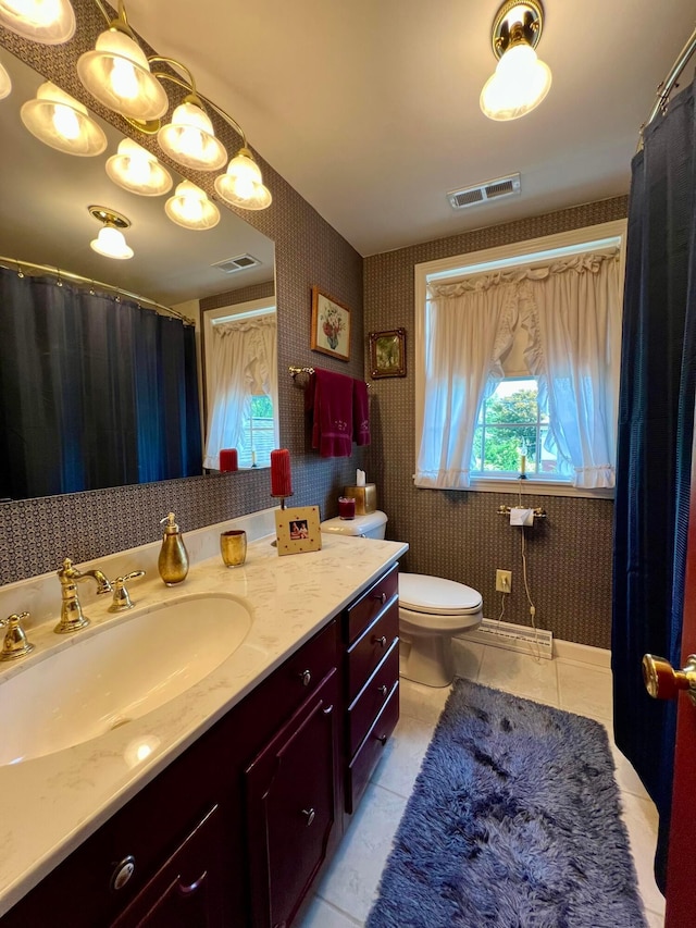 bathroom featuring vanity, tile patterned floors, and toilet