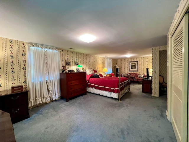 bedroom with carpet and a closet