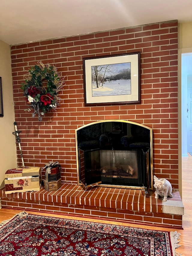 interior details with hardwood / wood-style flooring and a fireplace