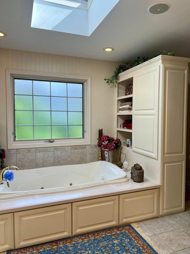 bathroom featuring tile patterned floors, a bathtub, and a skylight