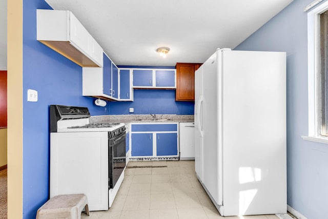 kitchen with white cabinetry, sink, light tile patterned floors, and white appliances