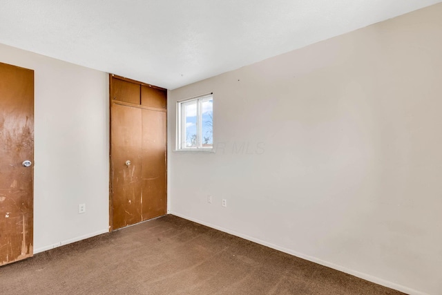 unfurnished bedroom with carpet floors and a closet