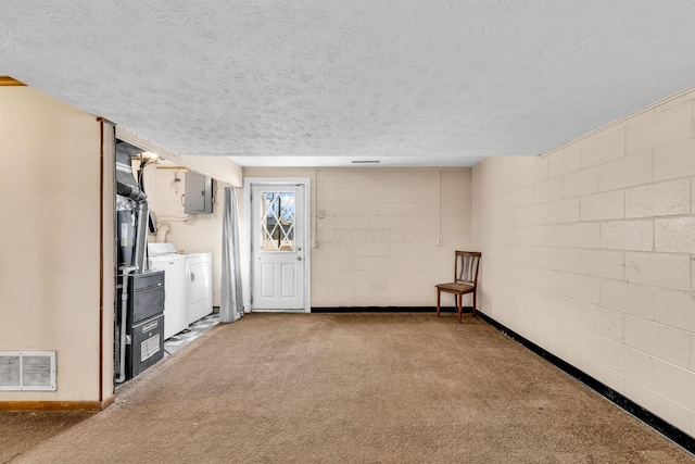 kitchen featuring separate washer and dryer, a textured ceiling, electric panel, and carpet