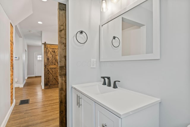 bathroom with vanity and wood-type flooring