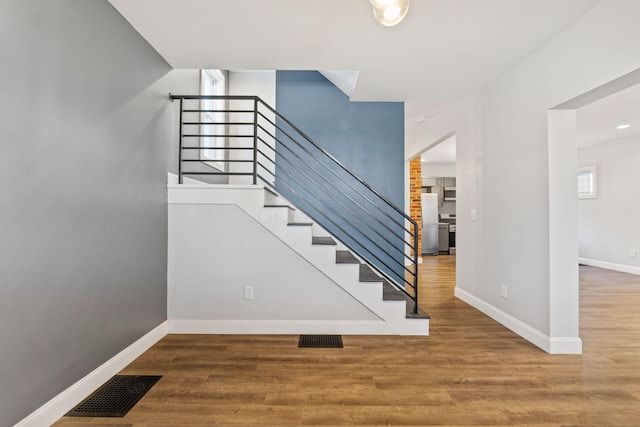 stairway with hardwood / wood-style floors