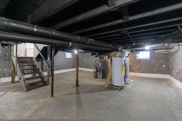 basement with strapped water heater and gas water heater