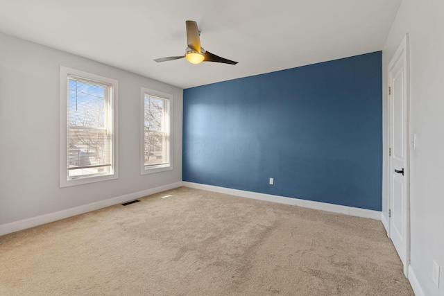 empty room with light carpet and ceiling fan