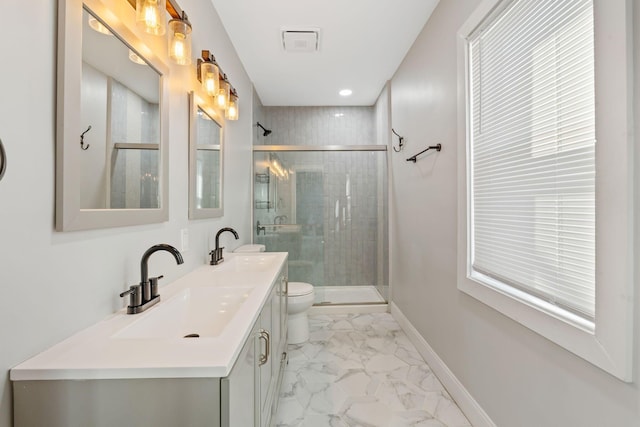 bathroom with walk in shower, vanity, and toilet