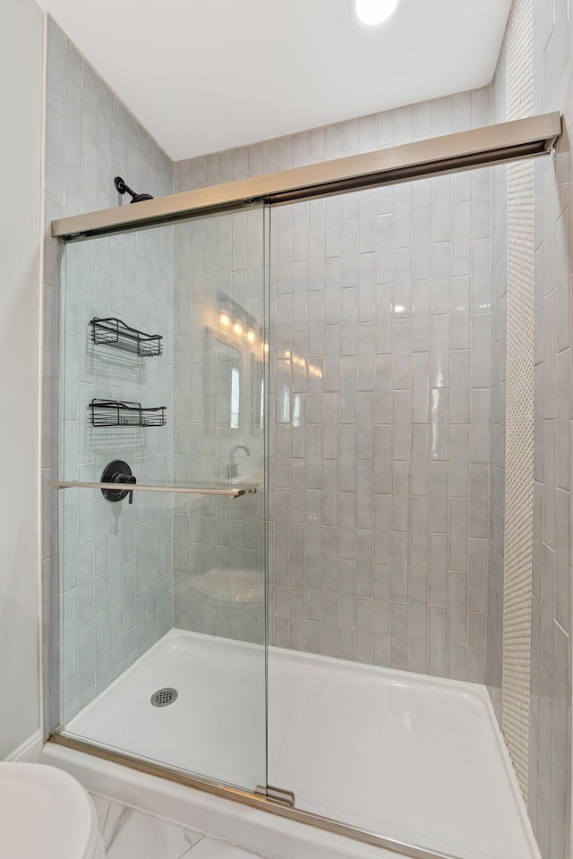 bathroom with a shower with shower door