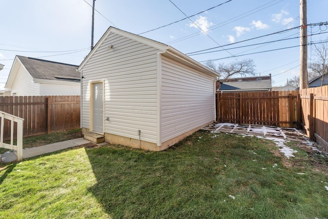 view of outbuilding with a yard