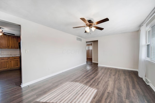 spare room featuring dark hardwood / wood-style floors and ceiling fan