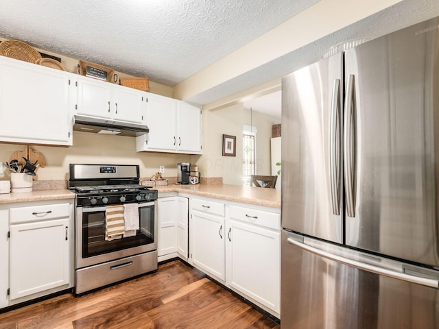 kitchen featuring white cabinetry, stainless steel appliances, dark hardwood / wood-style floors, and a textured ceiling