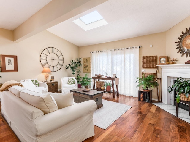 living room featuring hardwood / wood-style flooring, a fireplace, and a skylight