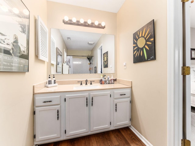 bathroom with vanity, curtained shower, and hardwood / wood-style floors