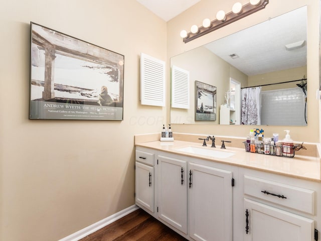 bathroom with vanity, hardwood / wood-style flooring, and a shower with curtain