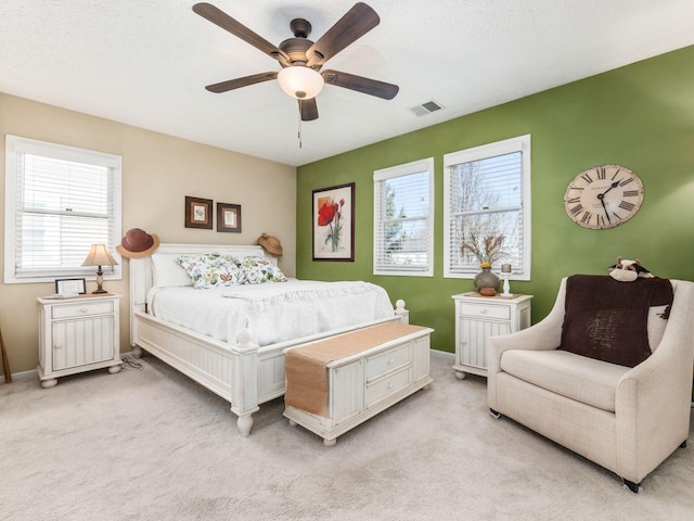 bedroom featuring light carpet and ceiling fan