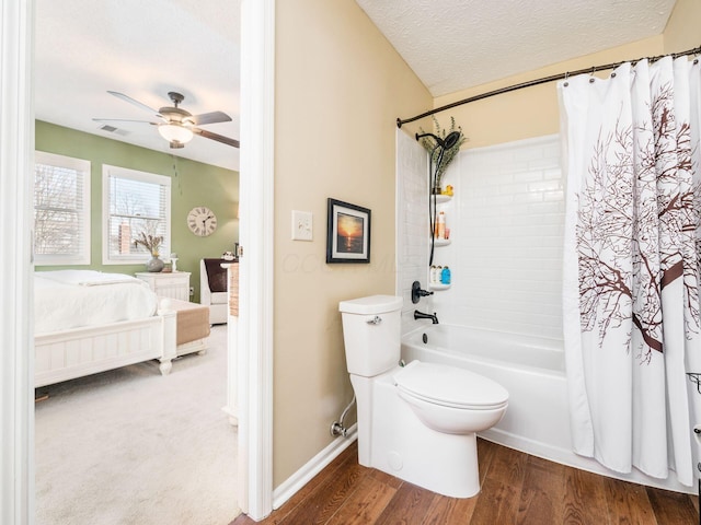 bathroom featuring hardwood / wood-style flooring, ceiling fan, toilet, a textured ceiling, and shower / bath combo with shower curtain