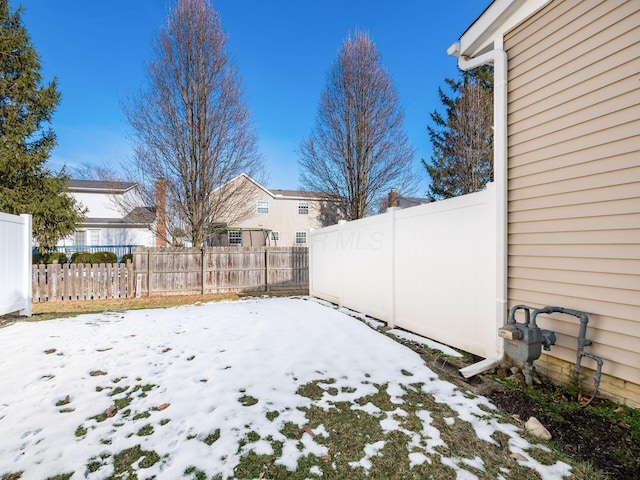 view of yard layered in snow