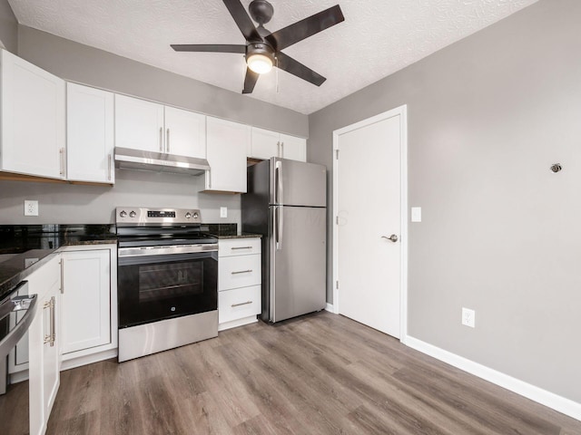 kitchen with stainless steel appliances, light wood-type flooring, white cabinets, and a textured ceiling