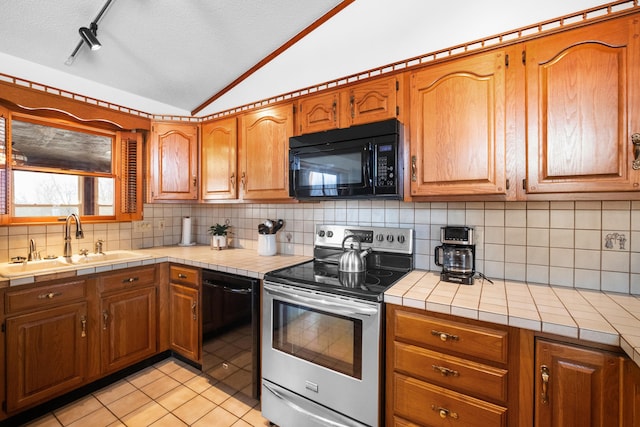 kitchen with backsplash, tile countertops, sink, and black appliances