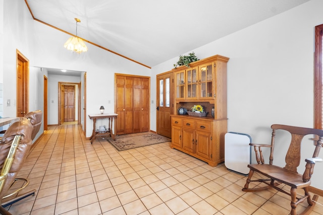 kitchen with pendant lighting, light tile patterned floors, vaulted ceiling, and a notable chandelier