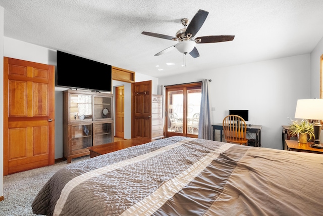 carpeted bedroom with a textured ceiling and ceiling fan