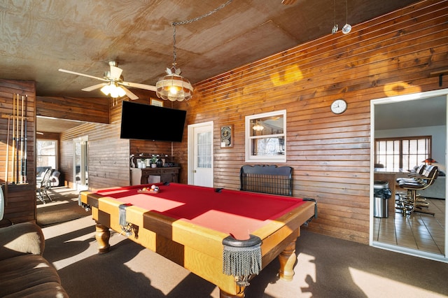 playroom featuring carpet, wooden walls, pool table, and ceiling fan