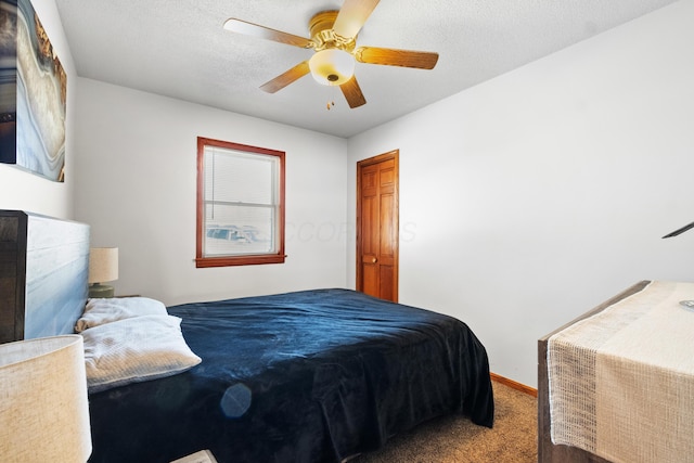 bedroom featuring ceiling fan, carpet floors, and a textured ceiling