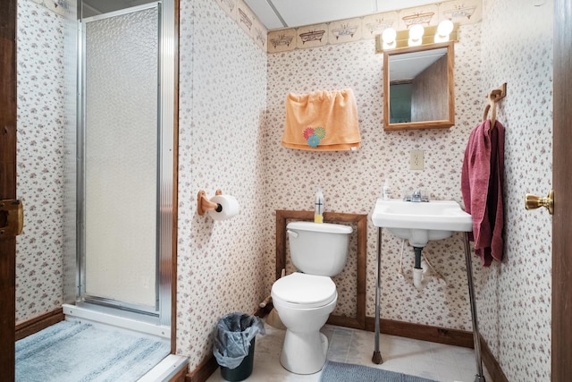 bathroom with tile patterned flooring, toilet, and walk in shower