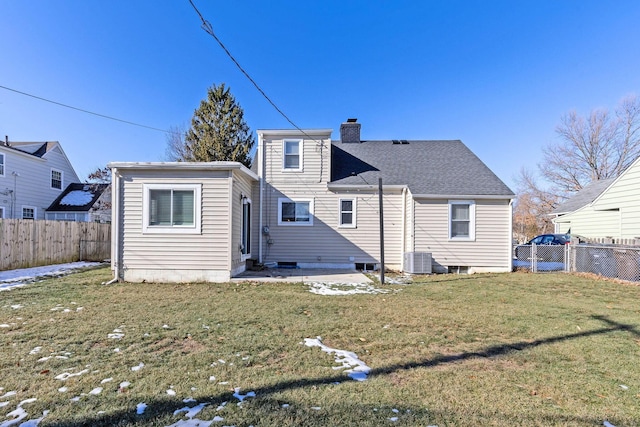 rear view of property featuring central AC, a patio, and a lawn