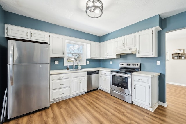 kitchen with stainless steel appliances, sink, and white cabinets