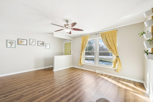 spare room featuring dark hardwood / wood-style flooring and ceiling fan