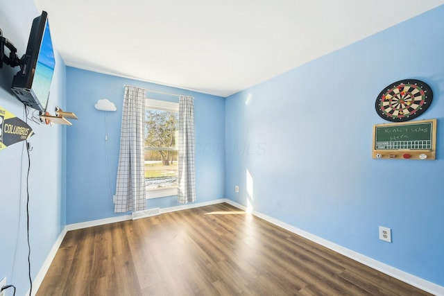 empty room featuring hardwood / wood-style flooring