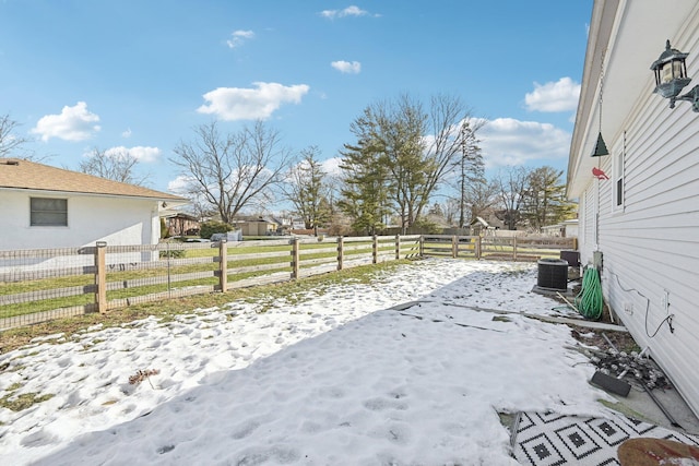 yard covered in snow featuring central air condition unit