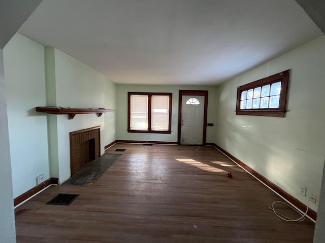 unfurnished living room with dark hardwood / wood-style flooring