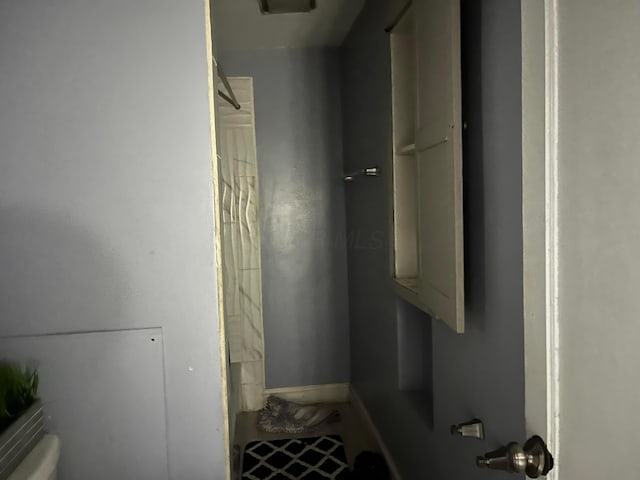 bathroom with toilet and walk in shower