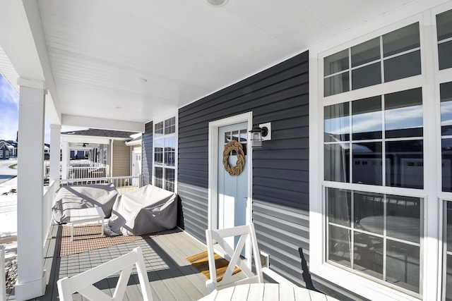 wooden terrace featuring covered porch