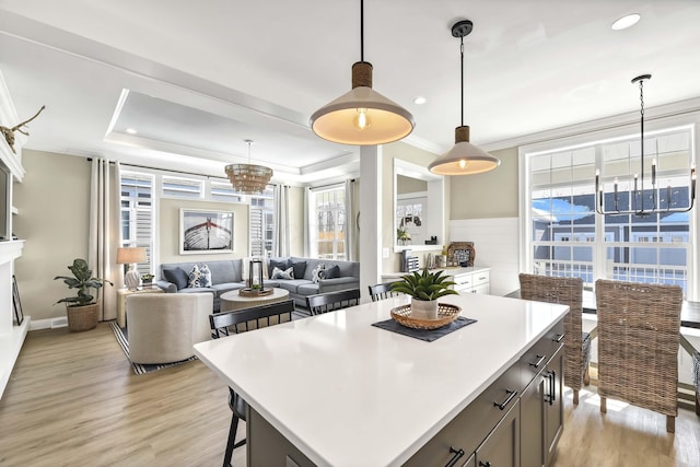 kitchen featuring decorative light fixtures, light hardwood / wood-style flooring, and a center island