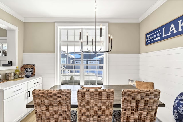 dining area with a notable chandelier and ornamental molding