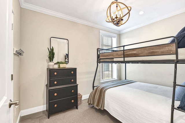 bedroom with crown molding, wood-type flooring, and a chandelier