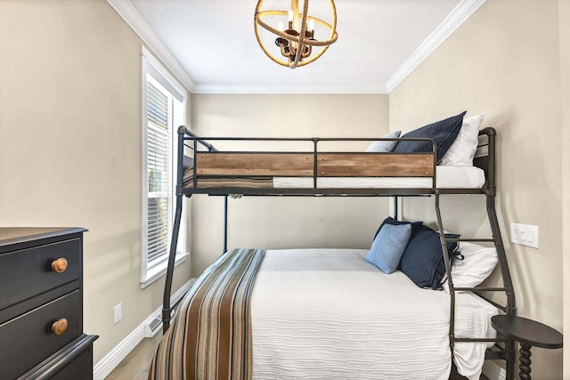 bedroom featuring crown molding, a chandelier, and hardwood / wood-style flooring