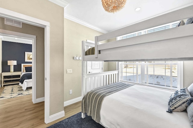 bedroom with ornamental molding and wood-type flooring