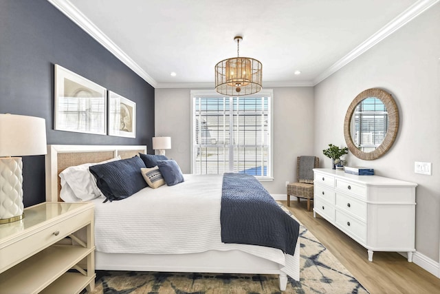 bedroom with crown molding, a notable chandelier, and light hardwood / wood-style flooring