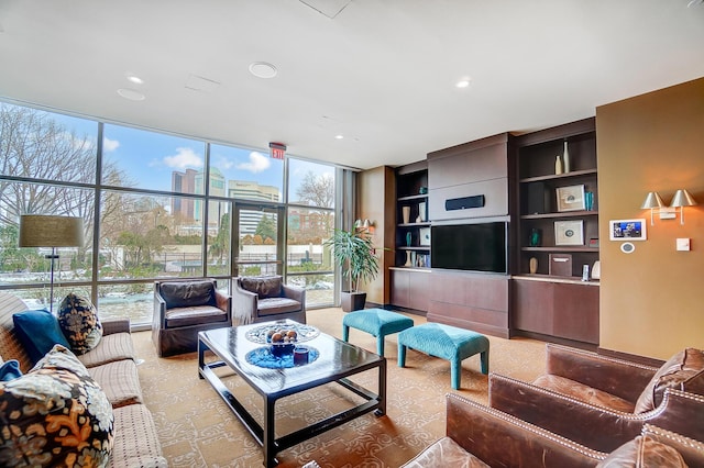 living room with built in shelves, plenty of natural light, and floor to ceiling windows