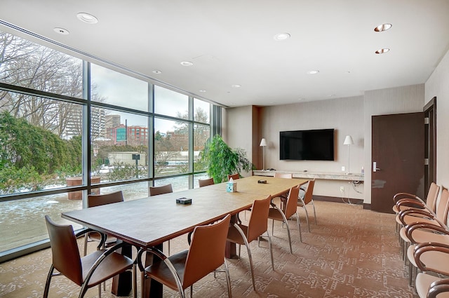 dining space featuring expansive windows and a healthy amount of sunlight